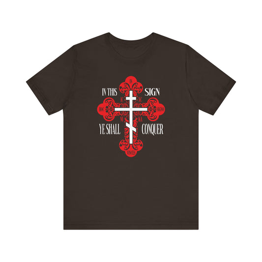 Brown lightweight cotton unisex tee featuring a red ornate Orthodox cross and the text "In This Sign Ye Shall Conquer," inspired by Orthodox prayer traditions.