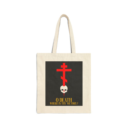 Natural canvas tote bag featuring a cross stabbing a skull with yellow text, "O Death Where is Thy Victory? (1 Corinthians 15:55)." An Orthodox Christian design inspired by the Resurrection.