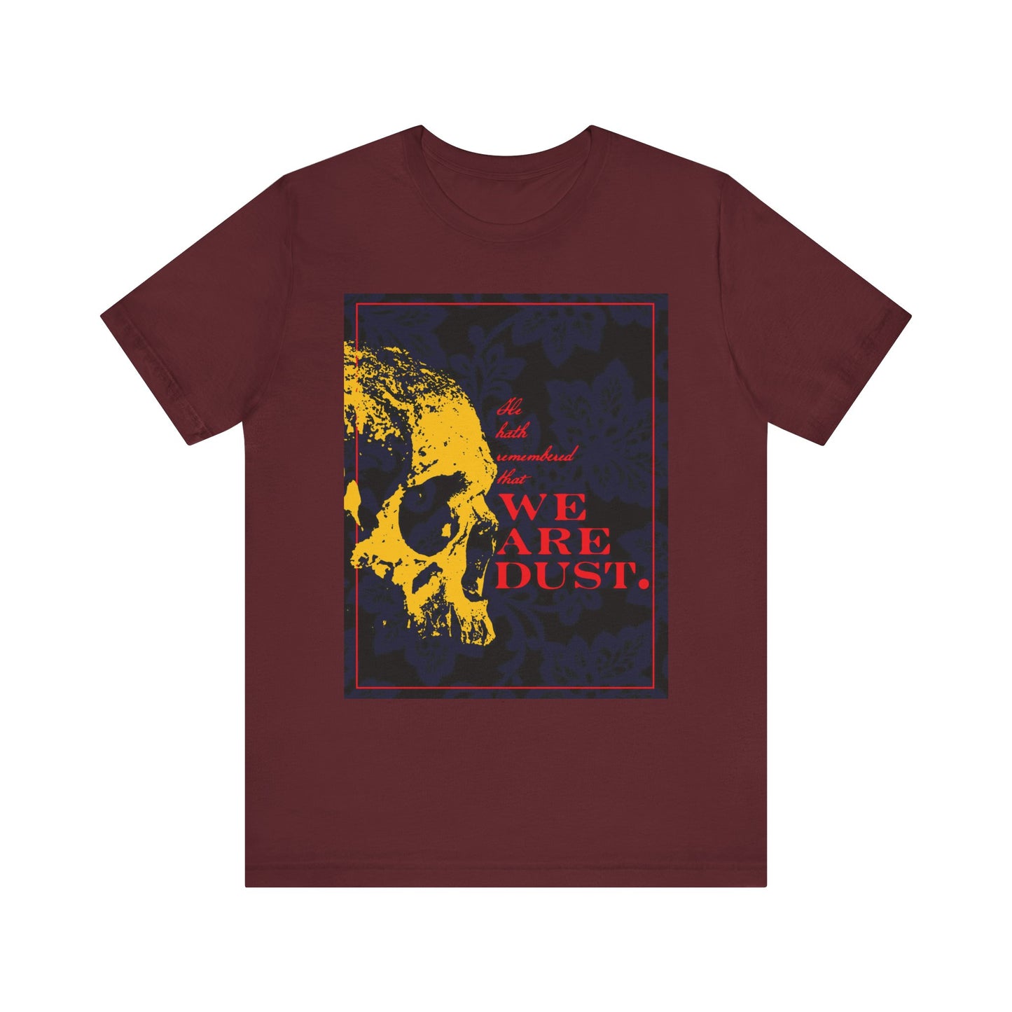 Maroon "We Are Dust" unisex tee features a yellow skull on a blue floral background with gothic red text, inspired by Psalm 102 (LXX) as a memento mori and reminder of God's compassion. Lightweight cotton for comfort.