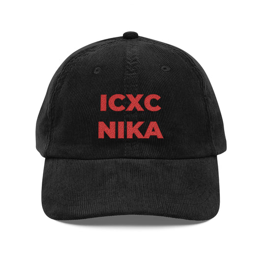 Black corduroy cap with red embroidered ICXC NIKA Christogram text, meaning "Jesus Christ Conquers." Orthodox Christian symbol; product name: Red ICXC NIKA Text Christogram Cap. Embroidered on soft black cotton.