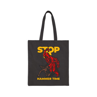 Carry the “St Marina of Antioch Beating the Devil with a Hammer | Stop, Hammer Time” canvas tote bag—featuring bold red, blue, and yellow art inspired by Orthodox memes and the legendary Christian martyr.