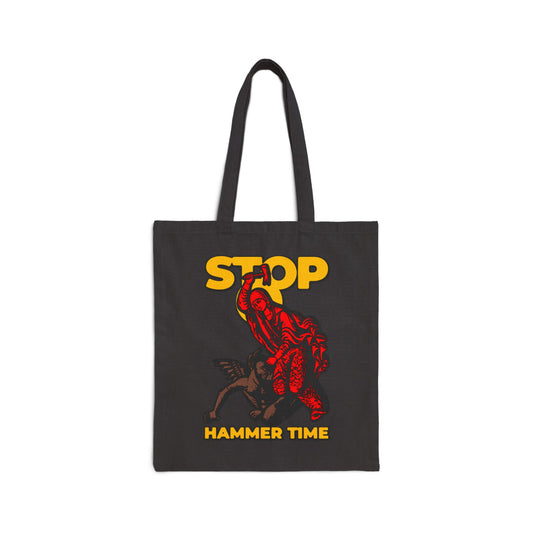 Carry the “St Marina of Antioch Beating the Devil with a Hammer | Stop, Hammer Time” canvas tote bag—featuring bold red, blue, and yellow art inspired by Orthodox memes and the legendary Christian martyr.