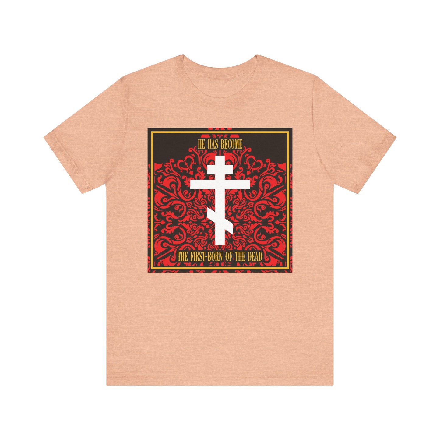 Heather Peach unisex tee with red floral square and white Orthodox cross; features the text "He Has Become the First-Born of the Dead," inspired by Jesus Christ as faithful witness. Lightweight cotton.