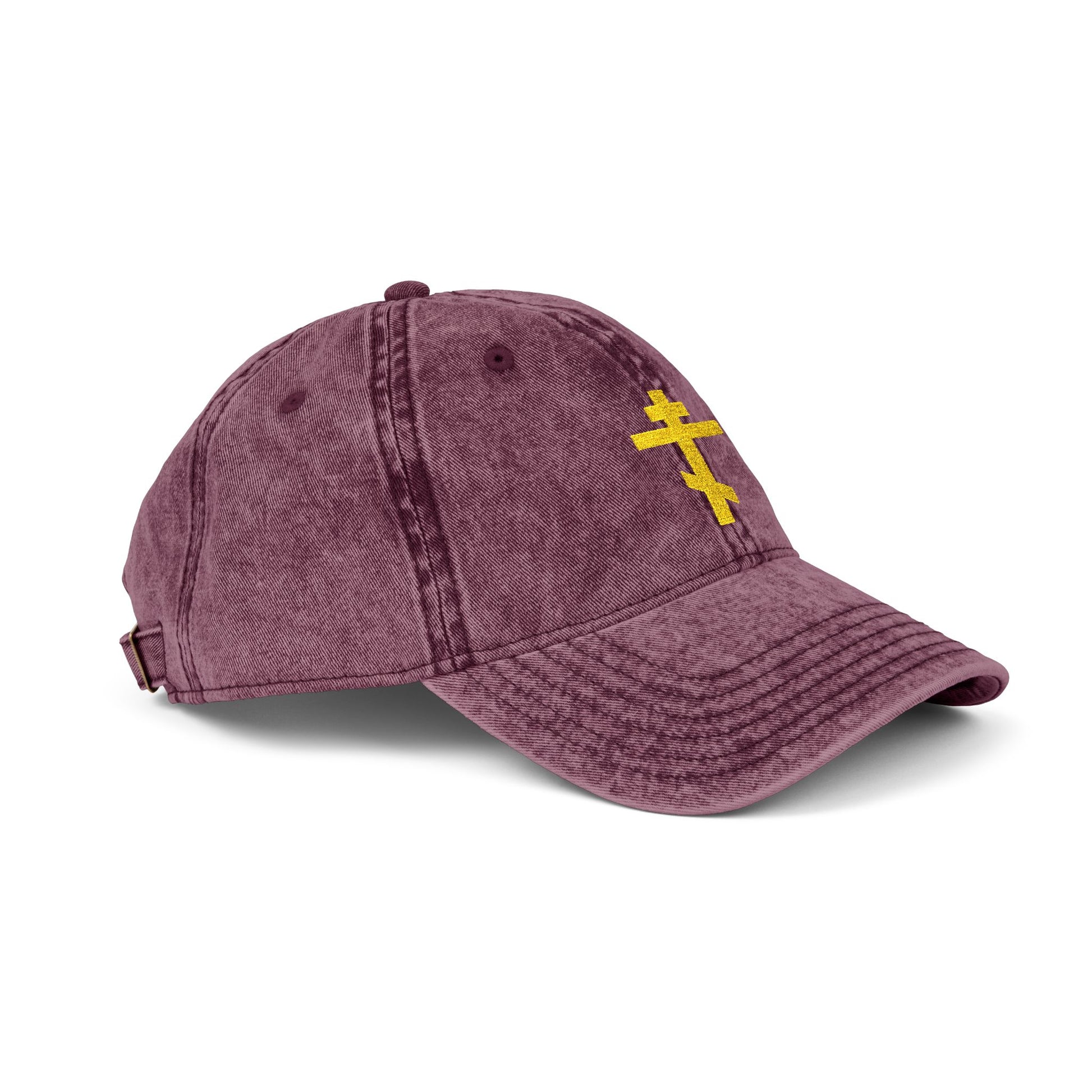 Maroon cap featuring a minimalist yellow Orthodox TriBar Cross, symbolizing salvation through Christ. "Crucify My Ego to the Precious and Life Giving Cross" embroidered on front. Distressed, Christian design.