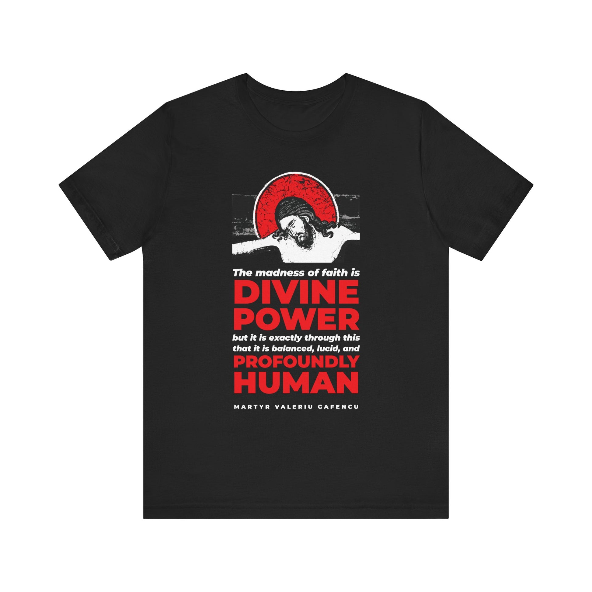 Black t-shirt titled "The madness of faith is divine power - Martyr Valeriu Gafencu of Romania," featuring a Christ IconoGraphic design with a haloed figure symbolizing spiritual awakening, and the words "DIVINE POWER...PROFOUNDLY HUMAN" boldly displayed in red and white. This Orthodox lightweight cotton unisex tee comes in black.