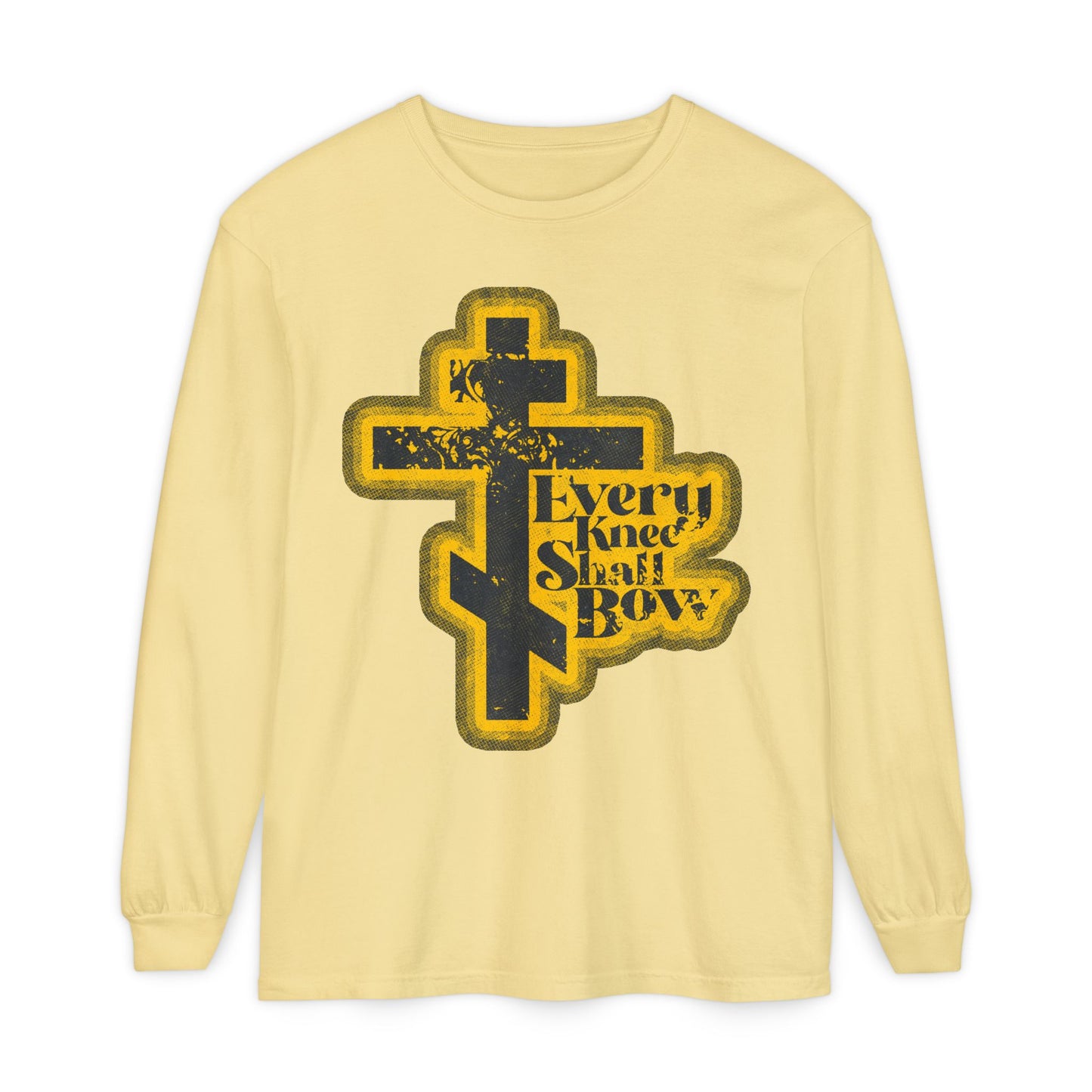 Butter-colored long sleeve with dark Orthodox cross and "Every Knee Shall Bow," inspired by Philippians 2:10-11 and Isaiah 45:23. Features a 70s distressed halftone comic book style, declaring Jesus Christ is Lord.