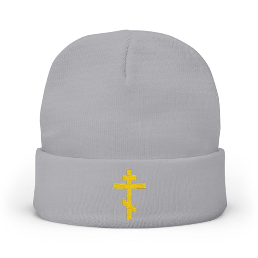 Gray knit beanie featuring a yellow Orthodox TriBar Cross embroidery and the phrase "Nail My Passions to the Wood of Thy Precious Cross O Lord." A meaningful accessory for Orthodox Christians.