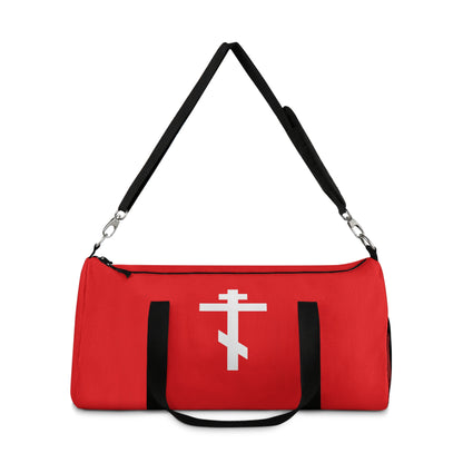 Red gym duffel bag featuring a white Orthodox cross on a red background and the verse "May I never boast, except in the cross of our Lord Jesus Christ" (Gal 6:14). Perfect for Orthodox Christians.