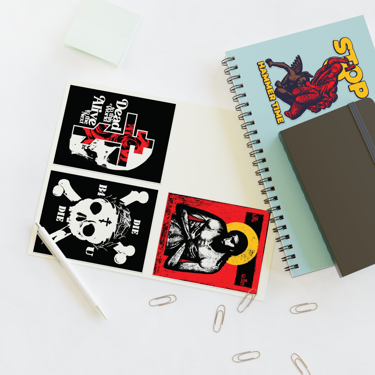 Open sketchbook with Random Mix No. 1 Four Sticker Sheet | Jesus Christ Iconographic | Dead to This World on desk.