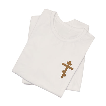 Two folded earthtone t-shirts, each with a small embroidered Orthodox cross on the front left, inspired by Galatians 6:14—"May I Never Boast Except in the Cross." Christian cotton unisex design.