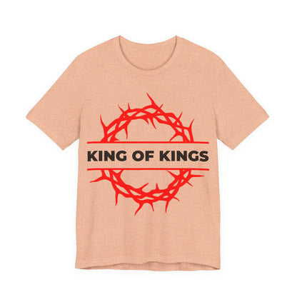 Heather Peach unisex cotton tee featuring a red crown of thorns and bold KING OF KINGS text, inspired by Revelation 19:16. "King of Kings Crown of Thorns | The King of Glory | Christ is King | Orthodox Christian Tee.
