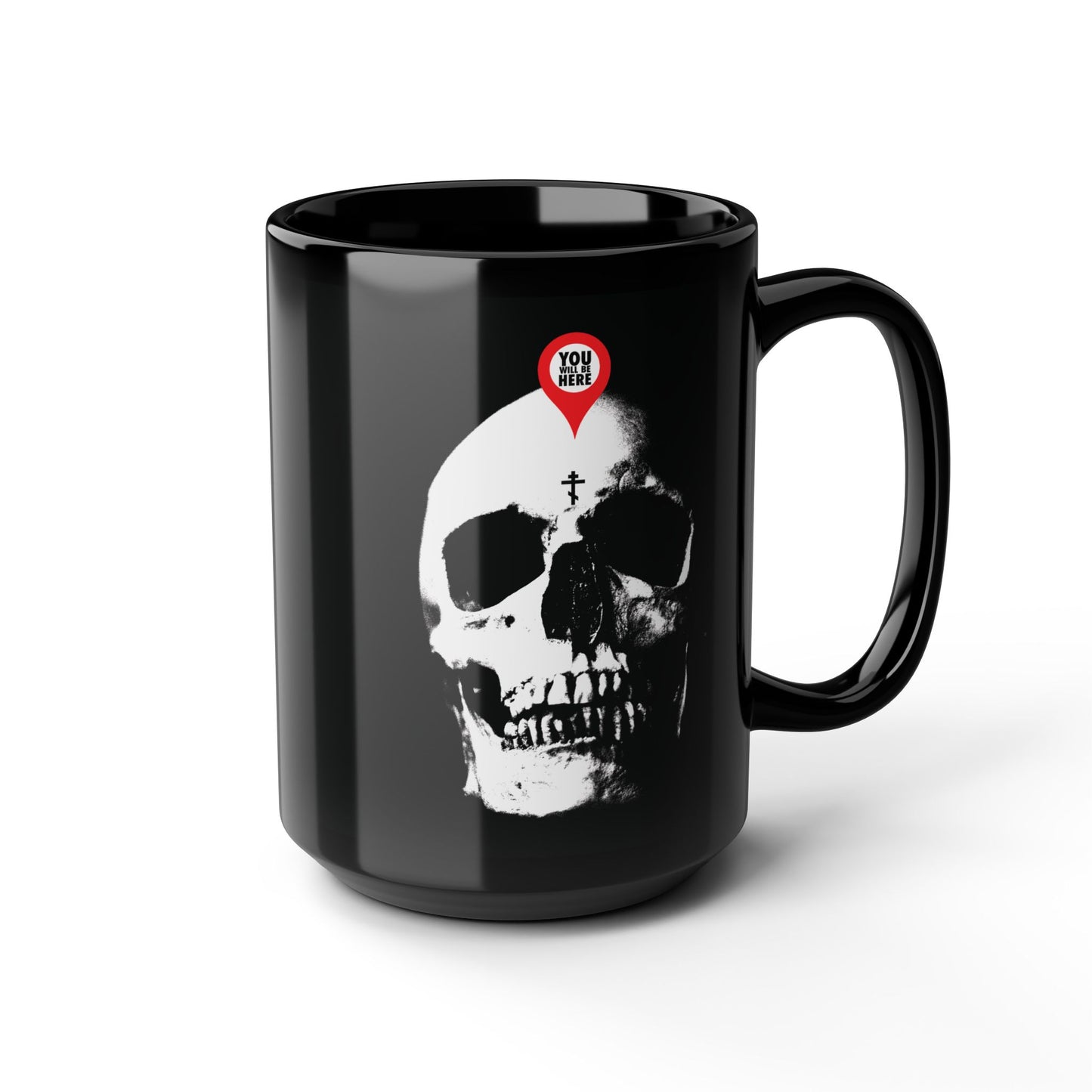 The "You Will Be Here" Orthodox Black Mug features a white skull with a red map marker on its forehead, inspired by St. Ignatius Brianchaninov’s memento mori reflections: "What you are I once was; remember you will die.