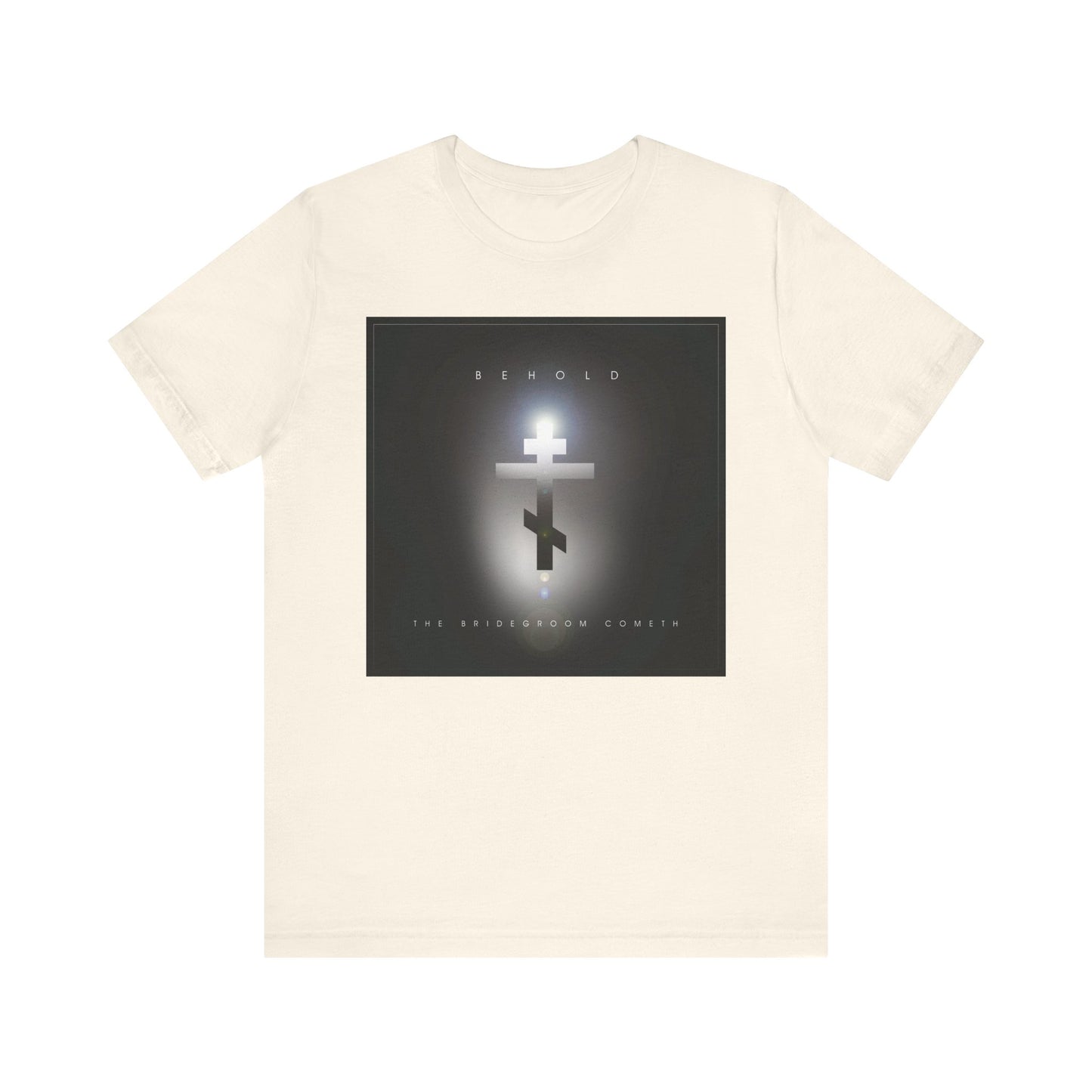 Natural unisex cotton t-shirt featuring a minimalist cinematic lens flare Orthodox cross and the words “BEHOLD The Bridegroom Cometh” on the front. Inspired by Orthodox Christian faith.