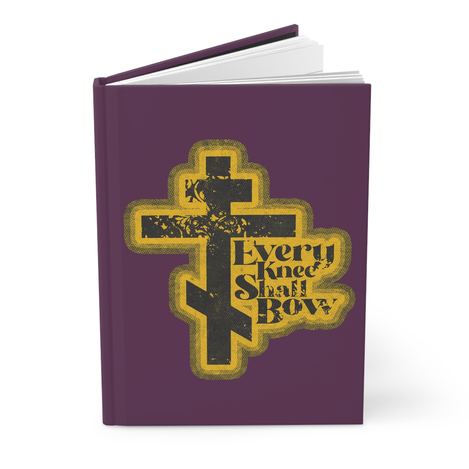 A purple journal titled "Every Knee Shall Bow" with a 70s distressed comic book aesthetic, featuring Philippians 2:10-11 and Isaiah 45:23; an Orthodox Christian blank notebook.