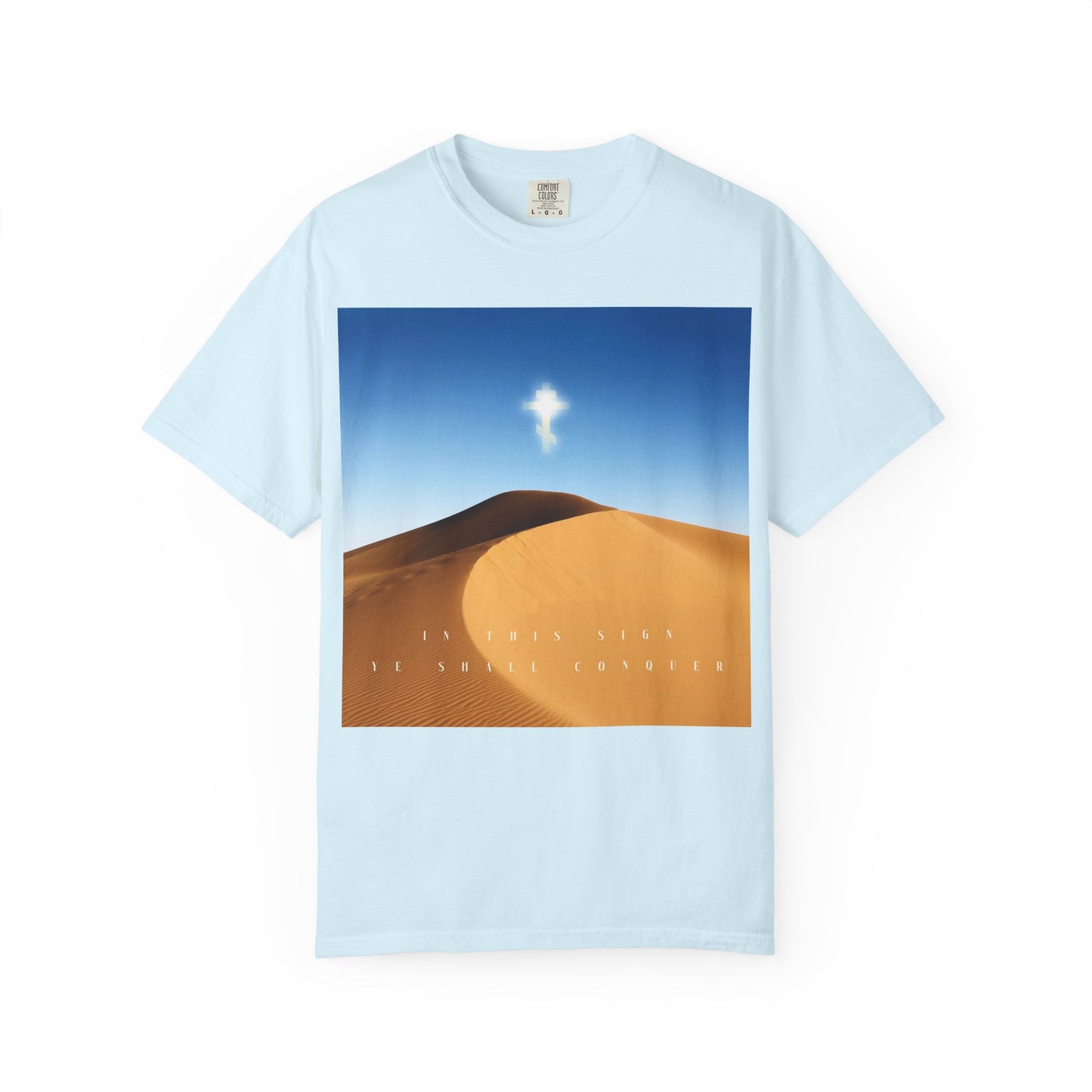 Chambray tee featuring a desert sun scene and a radiant cross in the sky, symbolizing the Elevation of the Cross, with the text "IN THIS SIGN YOU SHALL CONQUER.