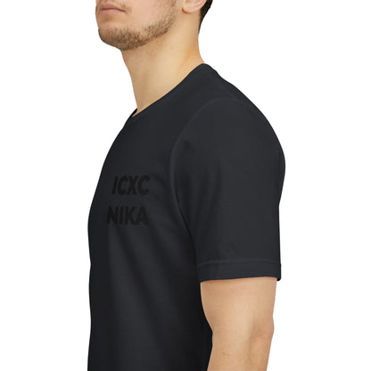 A man in a Black On Black Embroidered ICXC NIKA Christogram Unisex T-Shirt, featuring the Orthodox symbol meaning "Jesus Christ Conquers," is shown from the side against a plain background.