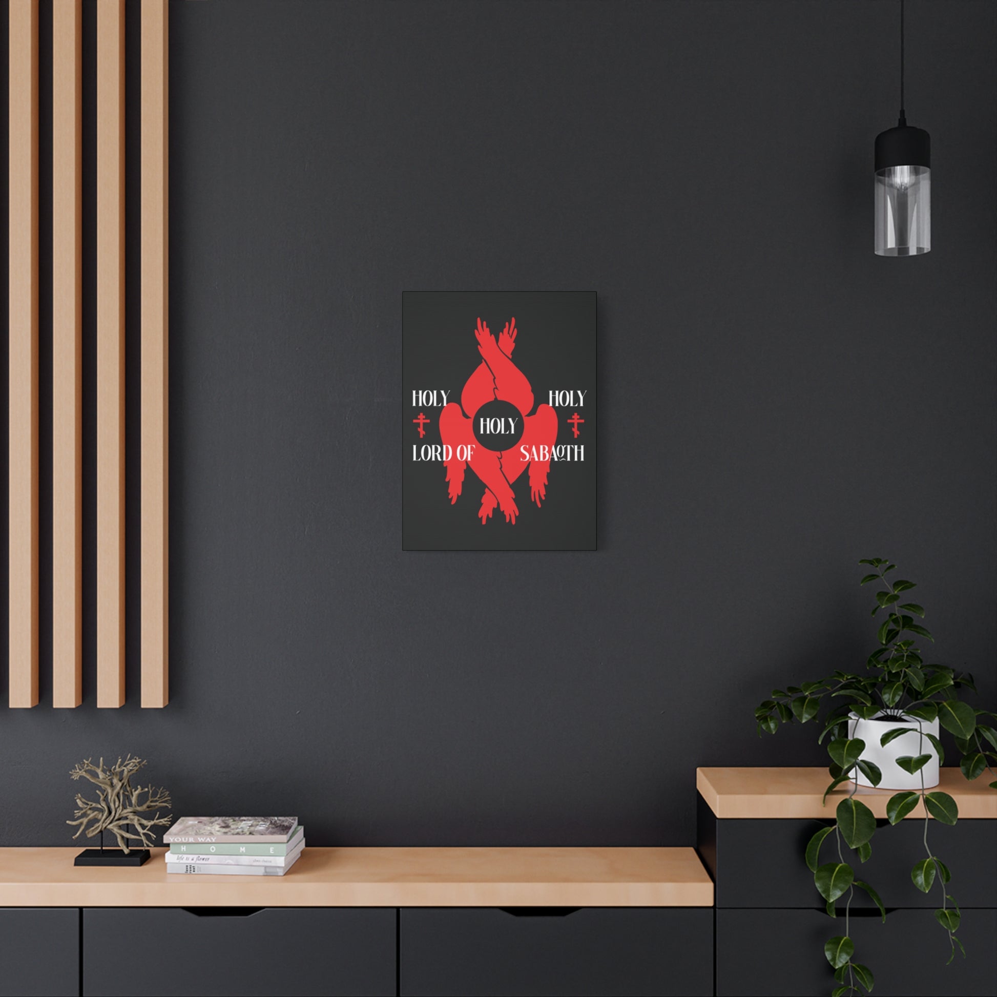 A modern room with dark walls, light wood shelves, and the "Holy Holy Holy Lord of Sabaoth Red Seraphim Wings Orthodox Crosses" Christian canvas art inspired by Isaiah 6:3 displayed on the wall.