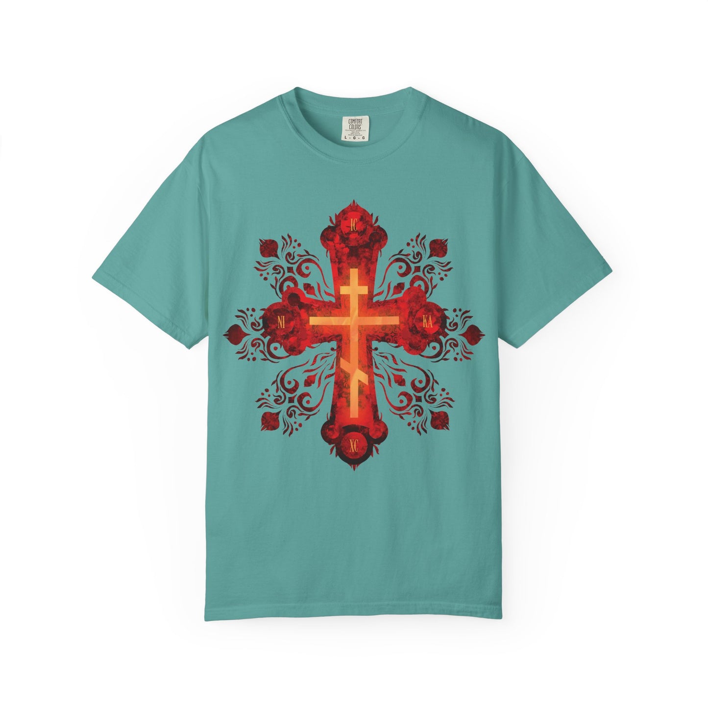Seafoam heavyweight cotton unisex tee showcasing a large, ornate Russian-style Orthodox cross in red and gold with intricate floral patterns and decorative swirls at the center, inspired by the spirit of a Christian warrior journeying toward the heavenly homeland. Features the phrase "He was pierced for our transgressions.