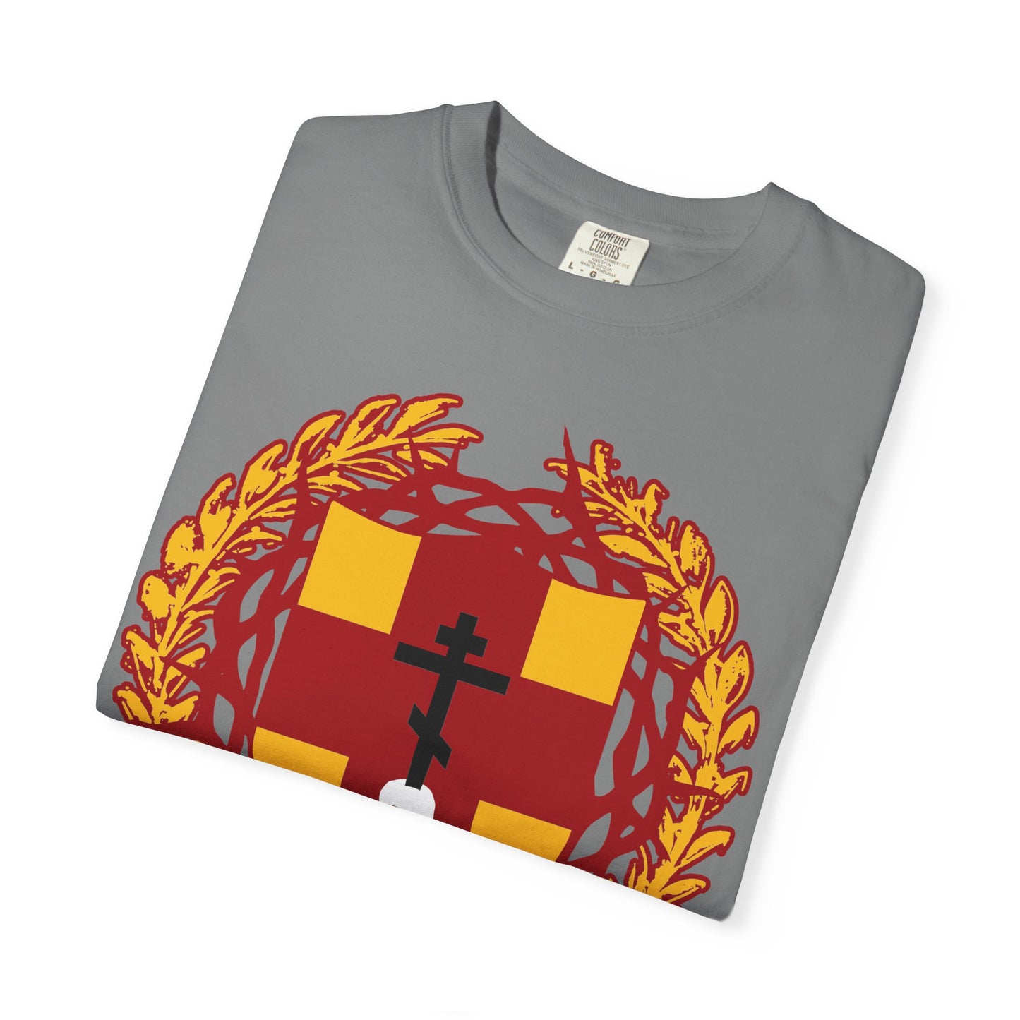 A folded gray “First-Born from the Dead (Col 1:18)” heavyweight cotton unisex t-shirt featuring a red and gold heraldic shield with an Orthodox cross, skull motif, and crown of thorns design inspired by biblical redemption.