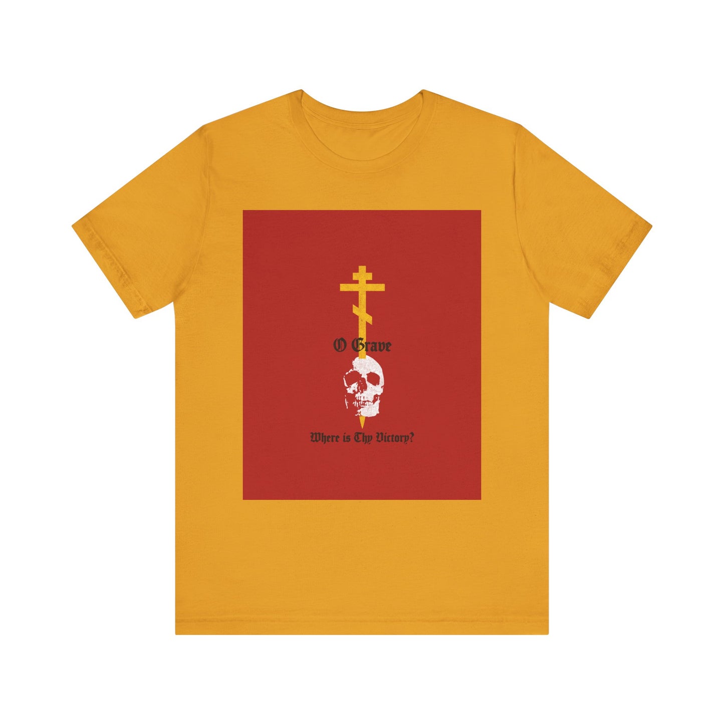 Mustard unisex cotton tee featuring a bold gold Orthodox cross piercing a white skull inside a red square, with the text: "O Grave, Where Is Thy Victory? 1 Cor 15:55"—a striking statement of salvation and resurrection.