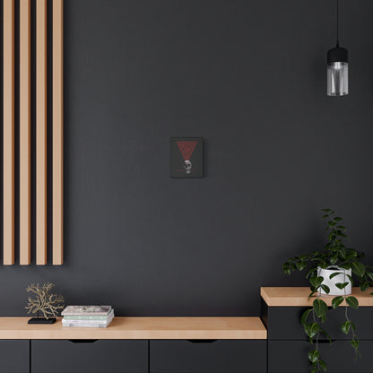 A modern black and wood room with books, a plant, and a pendant light features "The Present Day As the Last Day of Our Life" Orthodox canvas wall art—memento mori inspired by St John Climacus and adorned with a skull and red Orthodox cross.