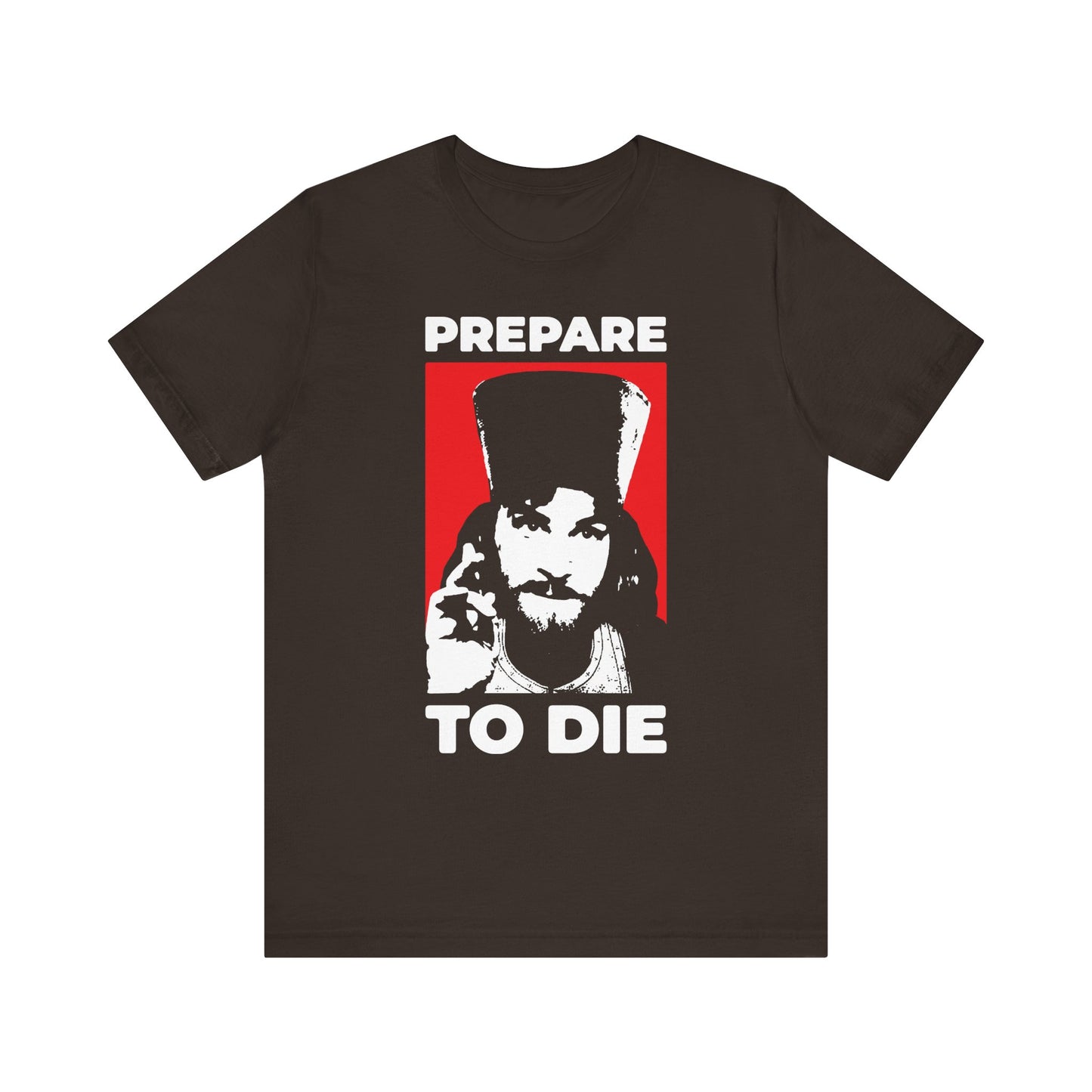 Brown T-shirt featuring "PREPARE TO DIE | REMEMBER YOU WILL DIE" and a bold graphic of Inigo Montoya as an Orthodox priest giving a blessing—a striking, faith-inspired design that recalls the teachings of St. Hesychius and encourages us to reflect on the hour of death with trust in the Lord Jesus Christ.