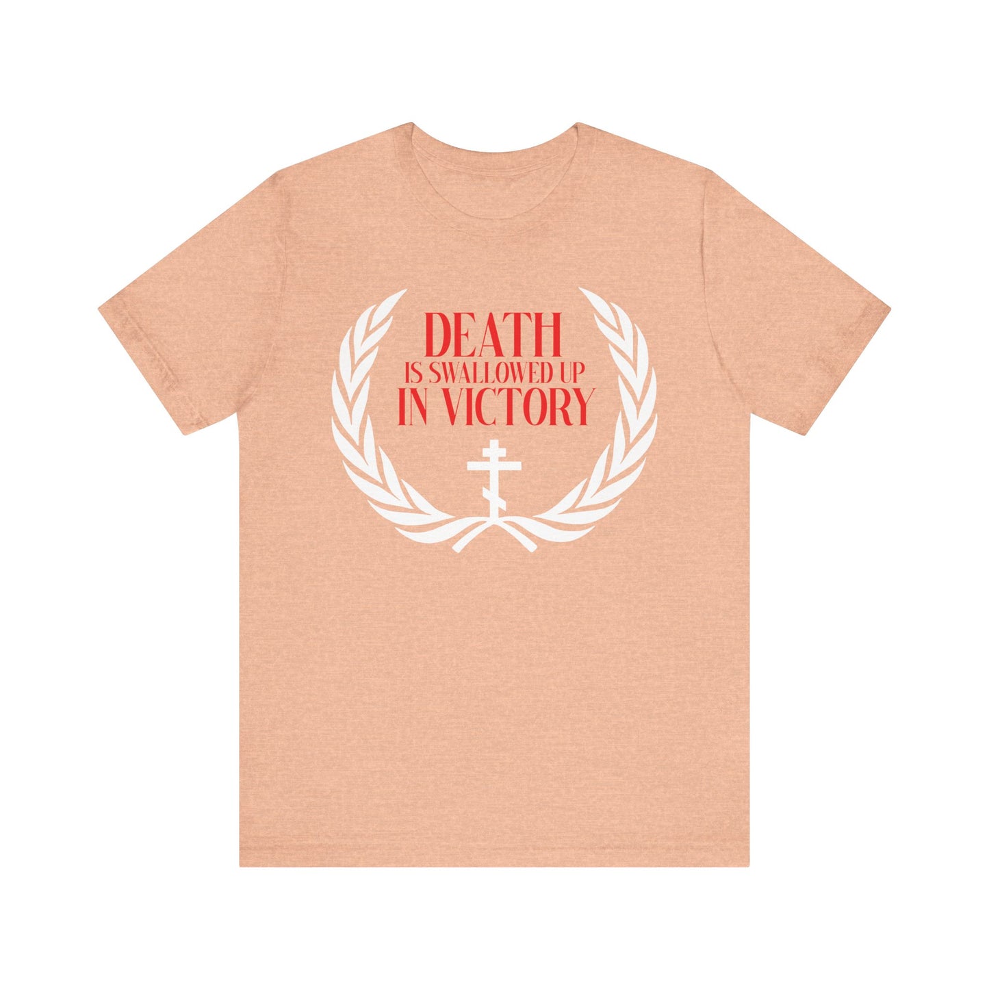 Heather Peach t-shirt with “Death is Swallowed Up In Victory” (1 Cor 15:54), an Orthodox cross, and a victory wreath—symbols of immortality and triumph over death. Lightweight cotton; perfect for Christian inspiration.