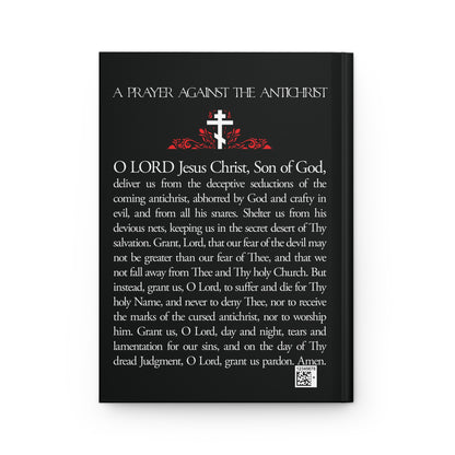 A black book cover titled "Prayer Against the Antichrist By Elder Anatoly the Younger of Optina | Christ is King," with a white cross, red accents, and Orthodox Christian prayer text inspired by the Book of Revelation. Blank journal.