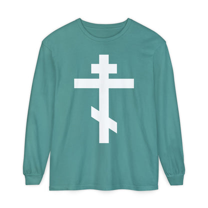Teal long-sleeve shirt featuring a large white Orthodox Cross and the message: “May I never boast, except in the cross of our Lord Jesus Christ” (Gal 6:14). Orthodox Long Sleeve Shirt inspired by spiritual tradition.