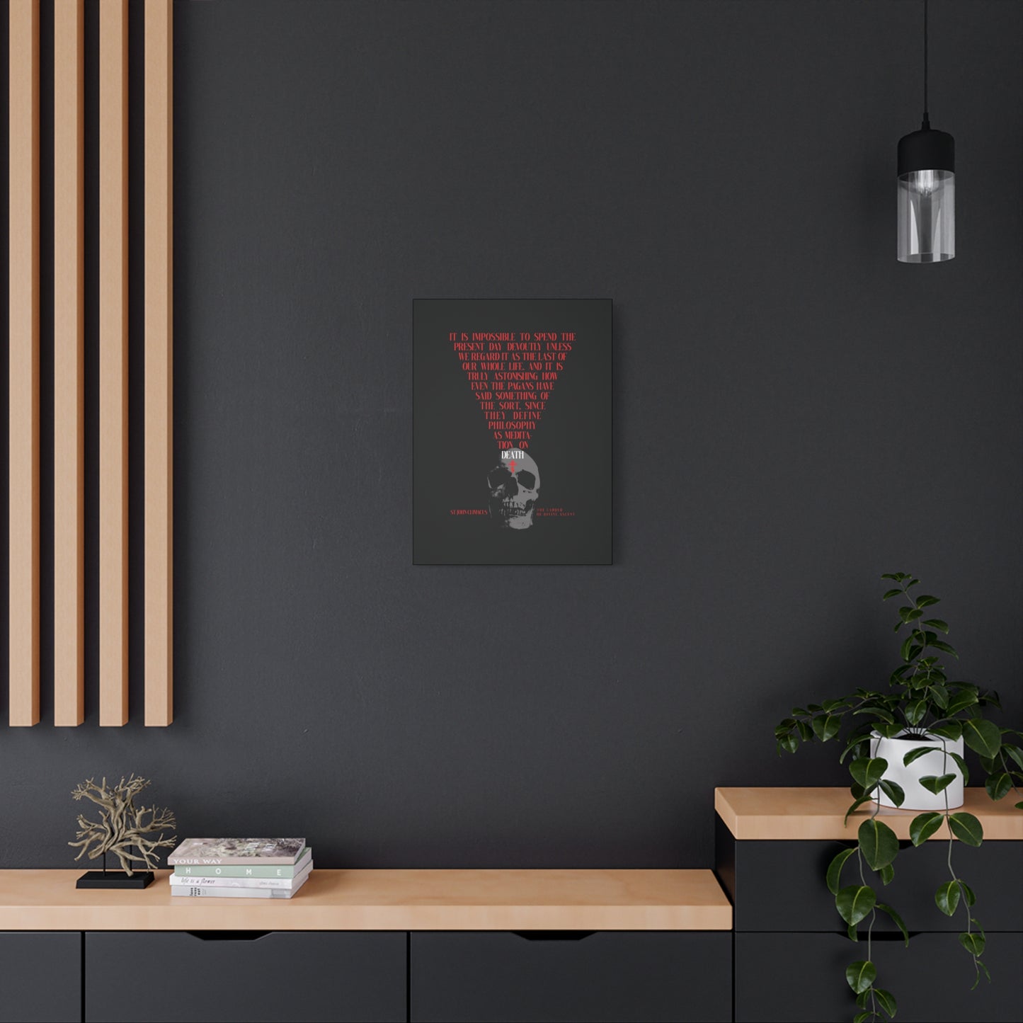 The Present Day As the Last Day of Our Life" Orthodox canvas wall art, featuring a skull with a red Orthodox cross, hangs above a modern minimalist sideboard with plants on a dark wall.