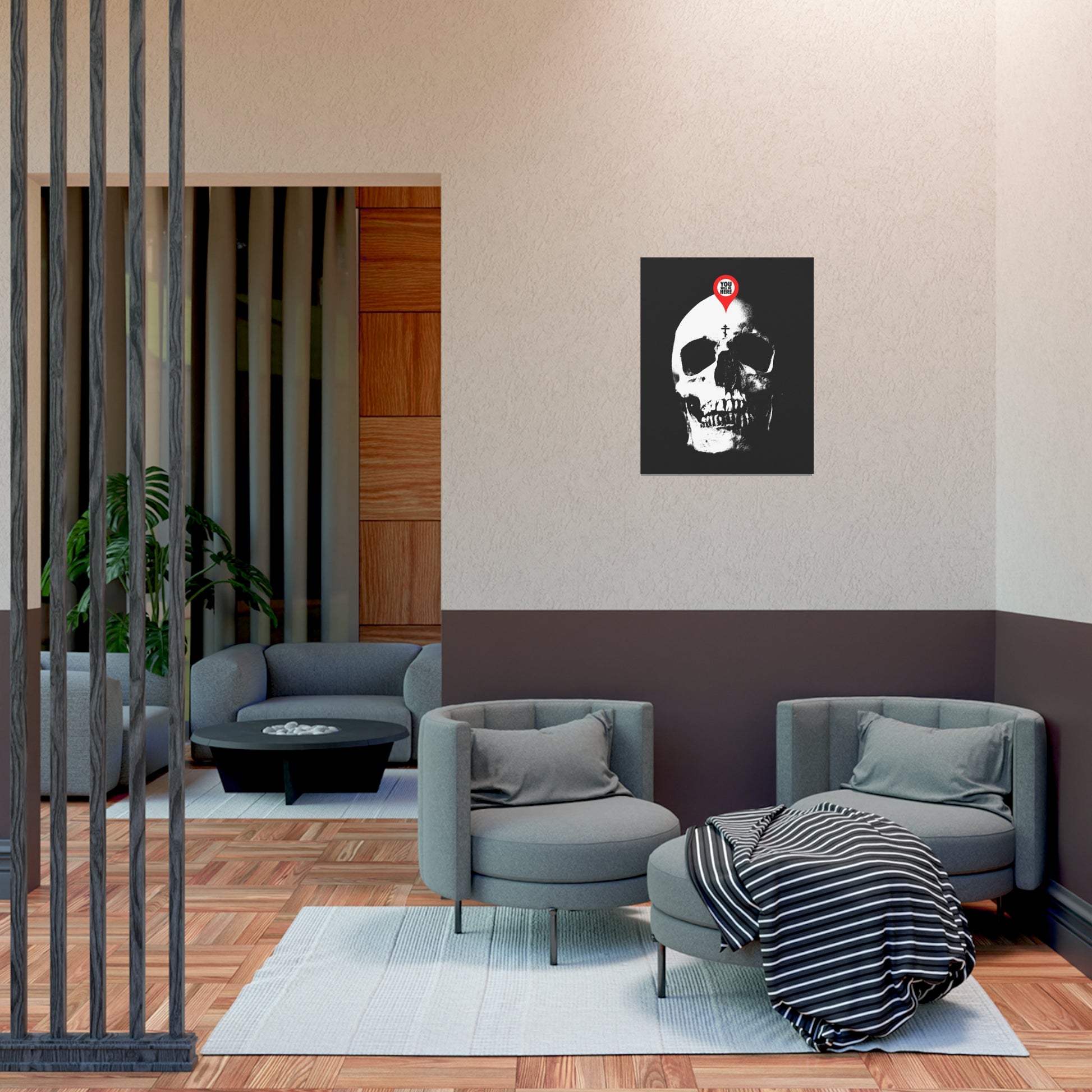 Modern living room with gray chairs, a striped blanket, and the “You Will Be Here Maps Marker on Skull” Orthodox Christian art poster—a memento mori echoing St. Ignatius Brianchaninov's reflections on spiritual death.