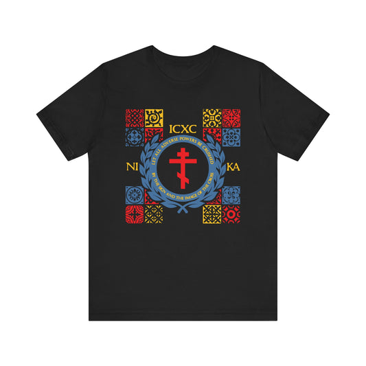 Black unisex “Let All Adverse Powers Be Crushed” t-shirt with red, yellow, and blue medieval tile design, ICXC NIKA Greek letters, and a reference to the Katavasia of the Cross—recalling Moses at the Red Sea—on lightweight cotton.