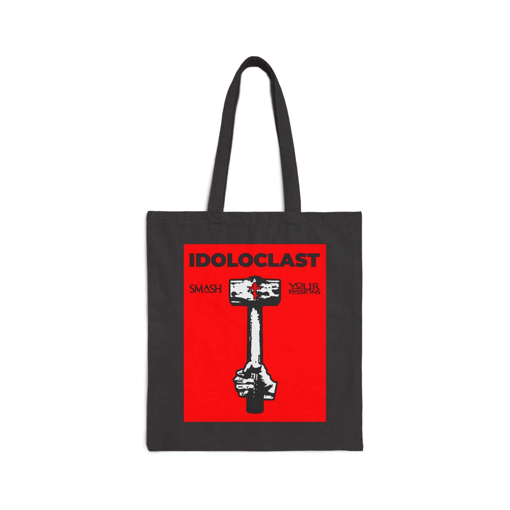 Carry the Idoloclast Idol-Smasher tote: a black cotton canvas bag featuring Jesus NIKA's fist with a sledgehammer on a red background and "Smash Your Passions"—perfect for those who challenge conventions.
