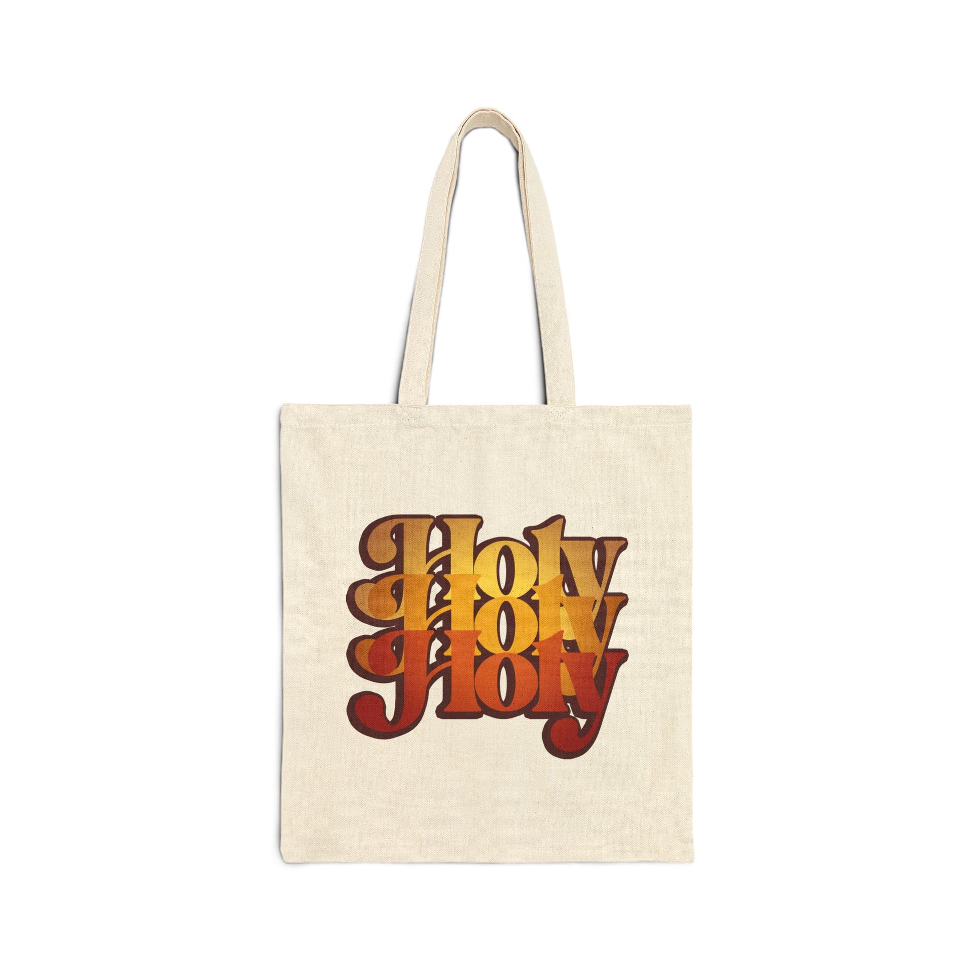Natural tote bag featuring "Holy Holy Holy" in bold, retro orange and brown lettering inspired by Isaiah 6, with a 70s-style Trisagion design rooted in Orthodox Christian tradition.