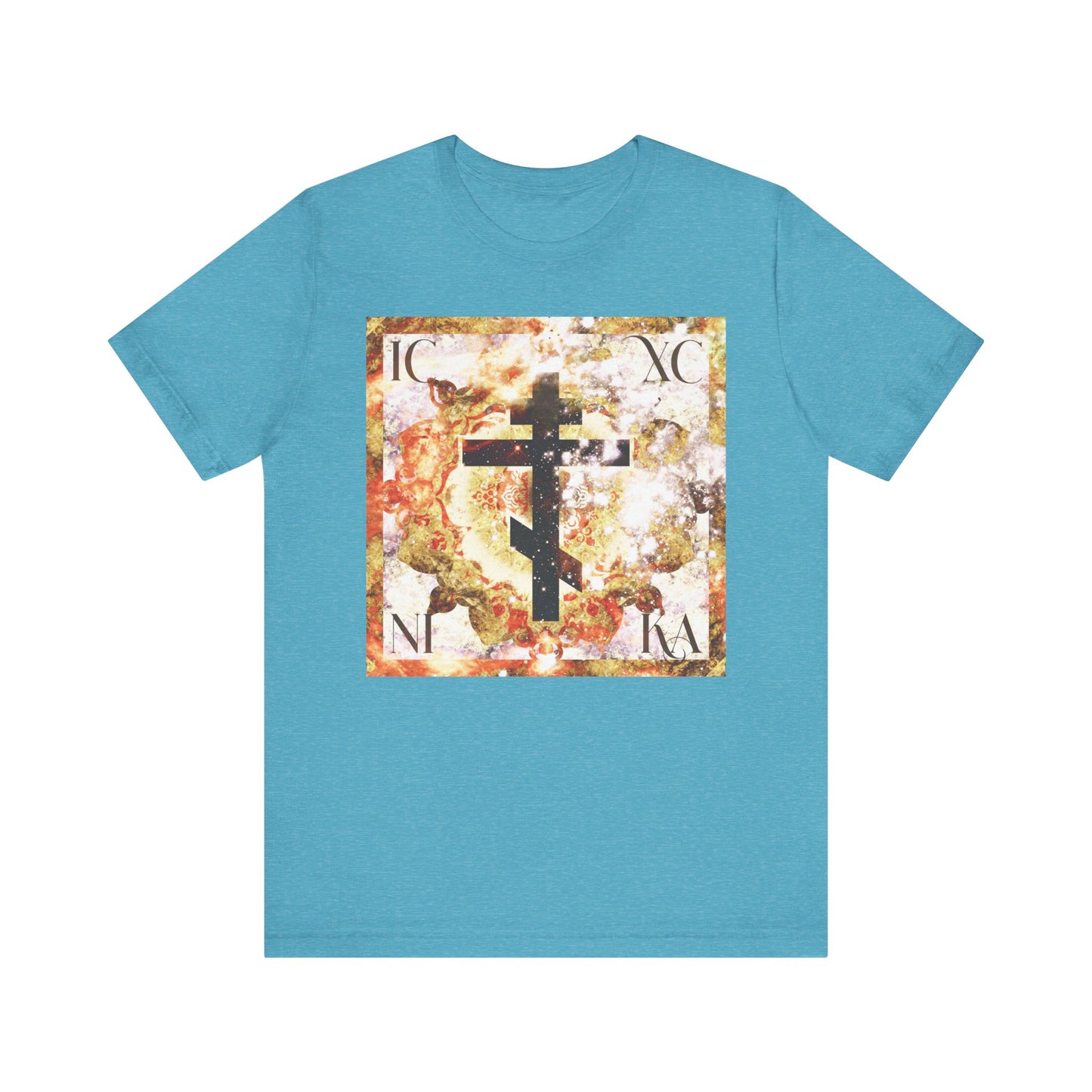 Heather aqua t-shirt featuring a glowing cosmic art cross with beige and brown textured design, displaying ICXC NIKA Greek letters—a symbolic representation of Divine and human nature revealed through Christ’s Incarnation.