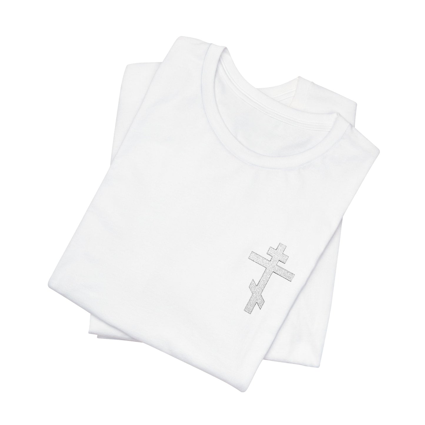 Two folded White on Light Small Embroidered Orthodox Cross t-shirts, one atop the other, crafted from soft Airlume combed cotton for a lightweight jersey feel and modern fit. Features “May I Never Boast Except in the Cross” (Gal 6:14). Unisex.