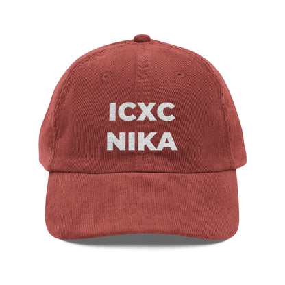 A burgundy cotton corduroy cap featuring the white embroidered ICXC NIKA Christogram, meaning "Jesus Christ Conquers," symbolizing Orthodox Christian faith.