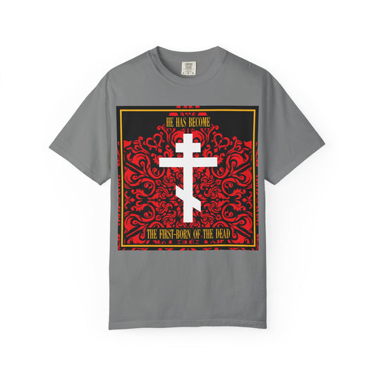 Presenting the "He Has Become the First-Born of the Dead" heavyweight cotton unisex tee in grey, featuring an elegant white Orthodox cross set against a rich red floral texture. This classic Christian t-shirt beautifully displays the bible verse: “He has become the first-born of the dead.” Perfect for expressing your faith with style and comfort.