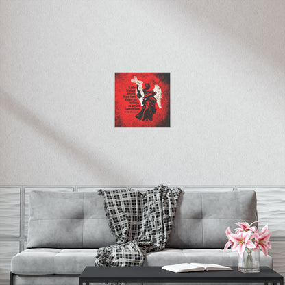 A gray couch with a plaid throw, pink flowers, and an open book sits below the "Little Divides Angels from Men" Orthodox Christian art poster by St John Chrysostom on a white wall, bringing inspiration to the serene space.
