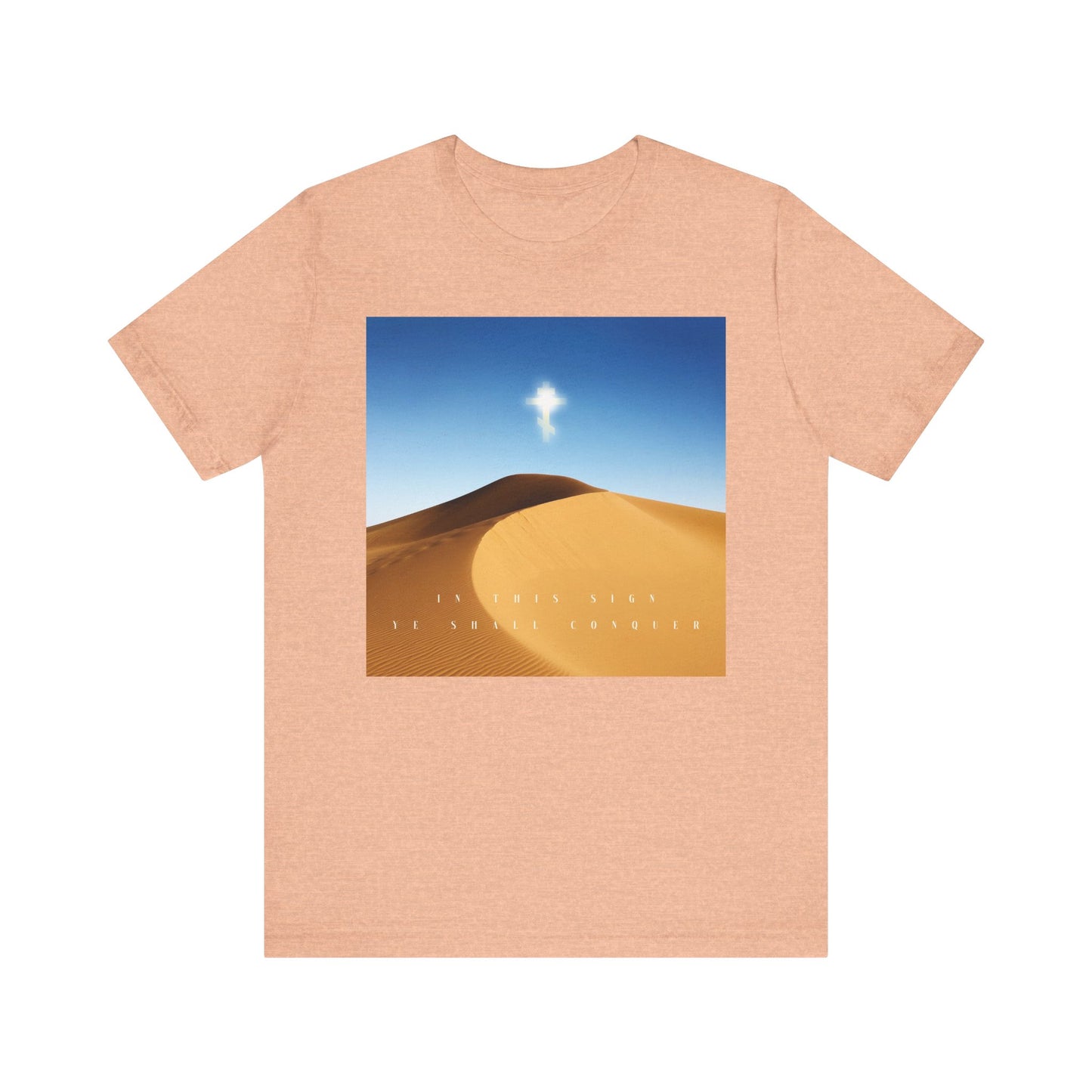 Heather Peach tee with a desert sun scene and the text: In This Sign Ye Shall Conquer—The Cross is the Might of Kings. An inspiring Orthodox Christian unisex cotton shirt.