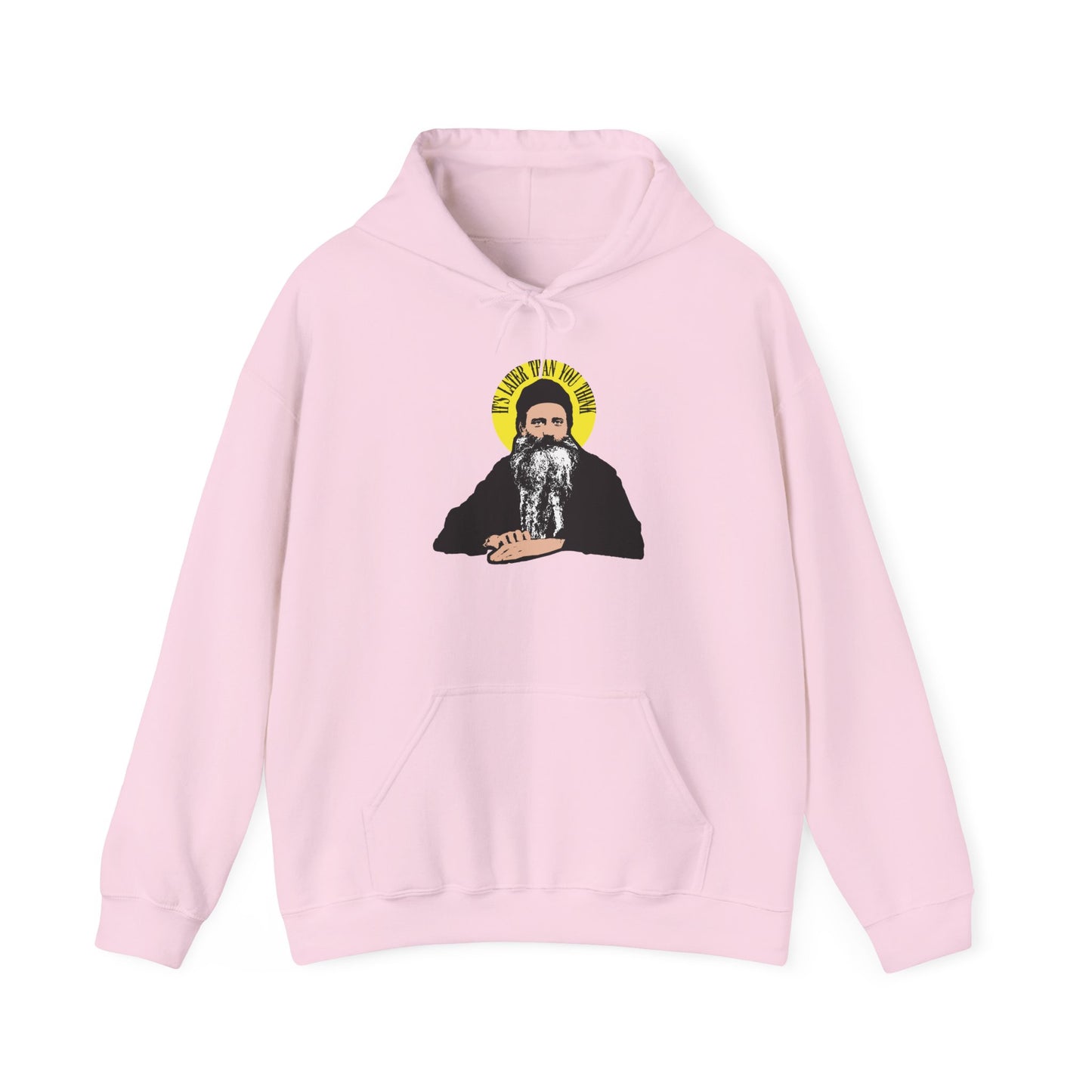 Light pink hoodie featuring a graphic of Fr Seraphim Rose—a bearded man with a yellow halo—and the phrase “It’s Later Than You Think” above his head, evoking fearsome angels and the contemplation of death.