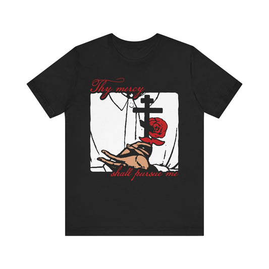 Black Thy Mercy Shall Pursue Me - Psalm 22 (23) lightweight cotton unisex t-shirt featuring an Orthodox Martyr's cross, rose, and praying hands in a striking icono-graphic style, accented with red text: "Thy mercy shall pursue me." Inspired by the path of righteousness and the assurance that the Lord is my shepherd.