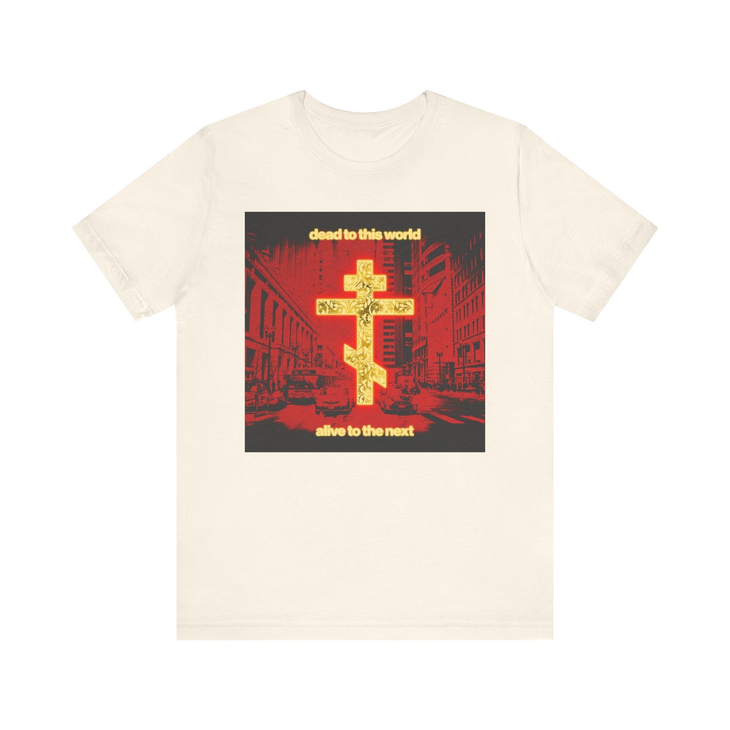 Natural-colored Orthodox Christian t-shirt featuring a glowing gold cross over a red cityscape and the phrase “Dead to This World, Alive to the Next”—a reminder of eternity. Lightweight cotton unisex tee.
