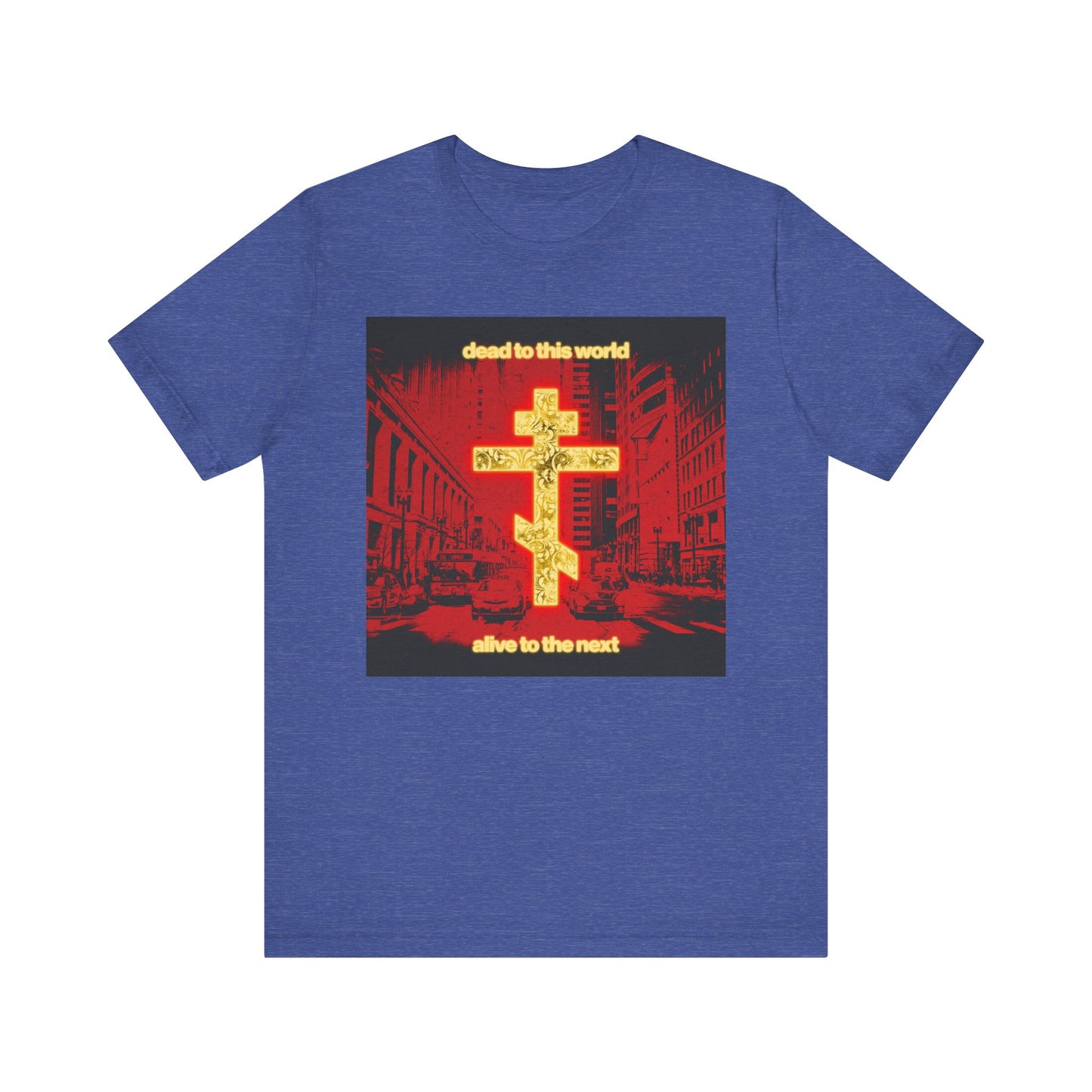 Heather True Royal "Dead to This World Alive to the Next" Orthodox Christian tee features a glowing gold cross over a red cityscape and bold front text—a reminder of eternity inspired by St Ignatius Brianchaninov. Unisex, lightweight cotton.