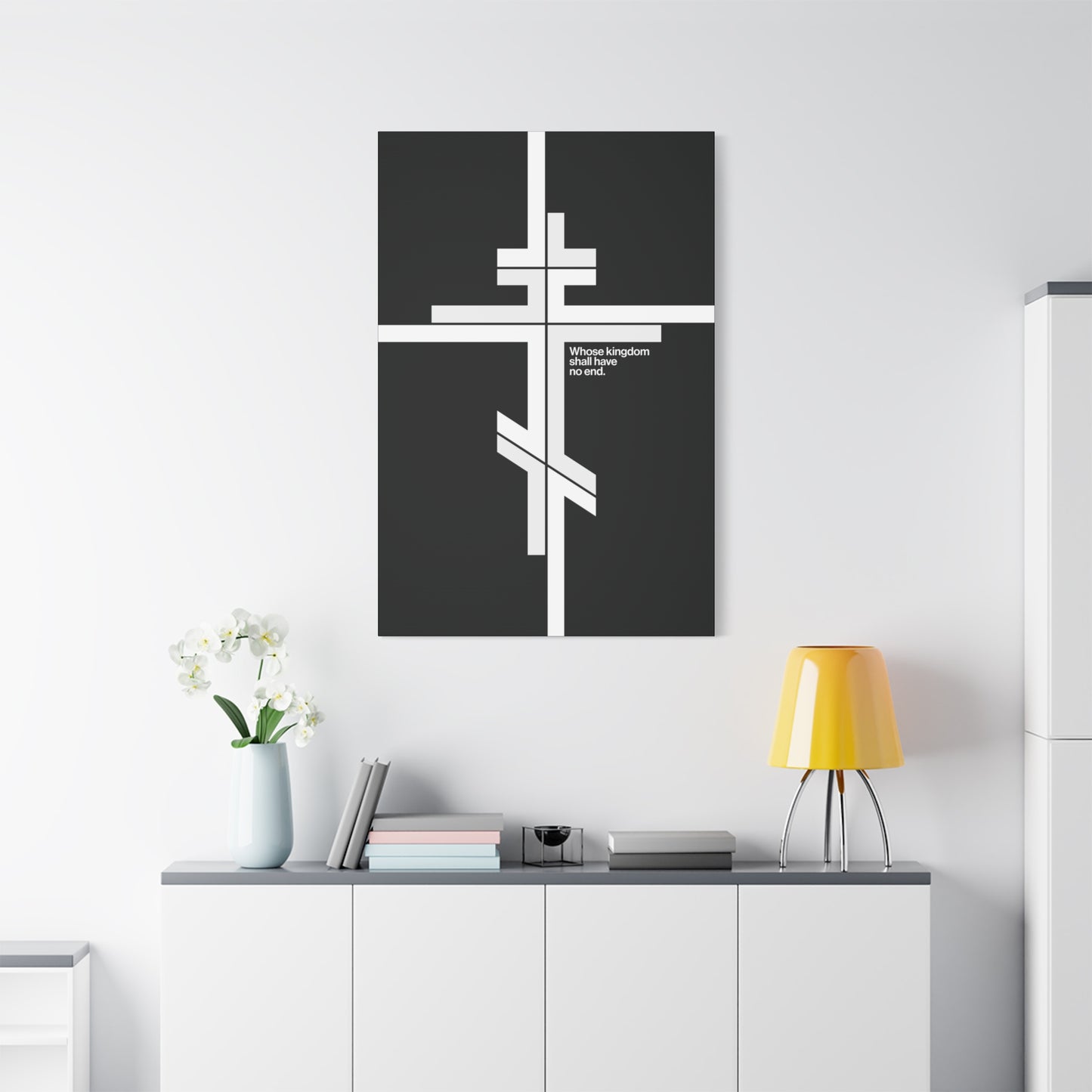 A minimalist room featuring a white cabinet, yellow lamp, blue vase, and "Whose Kingdom Shall Have No End" Orthodox Cross Christian canvas art—evoking Christ’s eternal kingdom through serene simplicity.