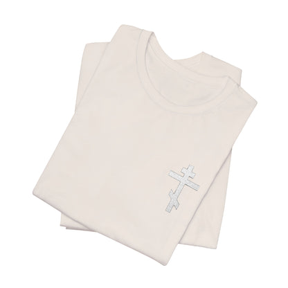 Two White on Light Small Embroidered Orthodox Cross unisex tees, crafted from soft Airlume combed cotton, featuring a silver cross design and Gal 6:14 inspiration, are neatly folded and displayed on a white background.