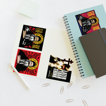 Fr Seraphim Rose Four Sticker Sheet No. 1 with bold designs on a desk next to notebooks and office supplies.