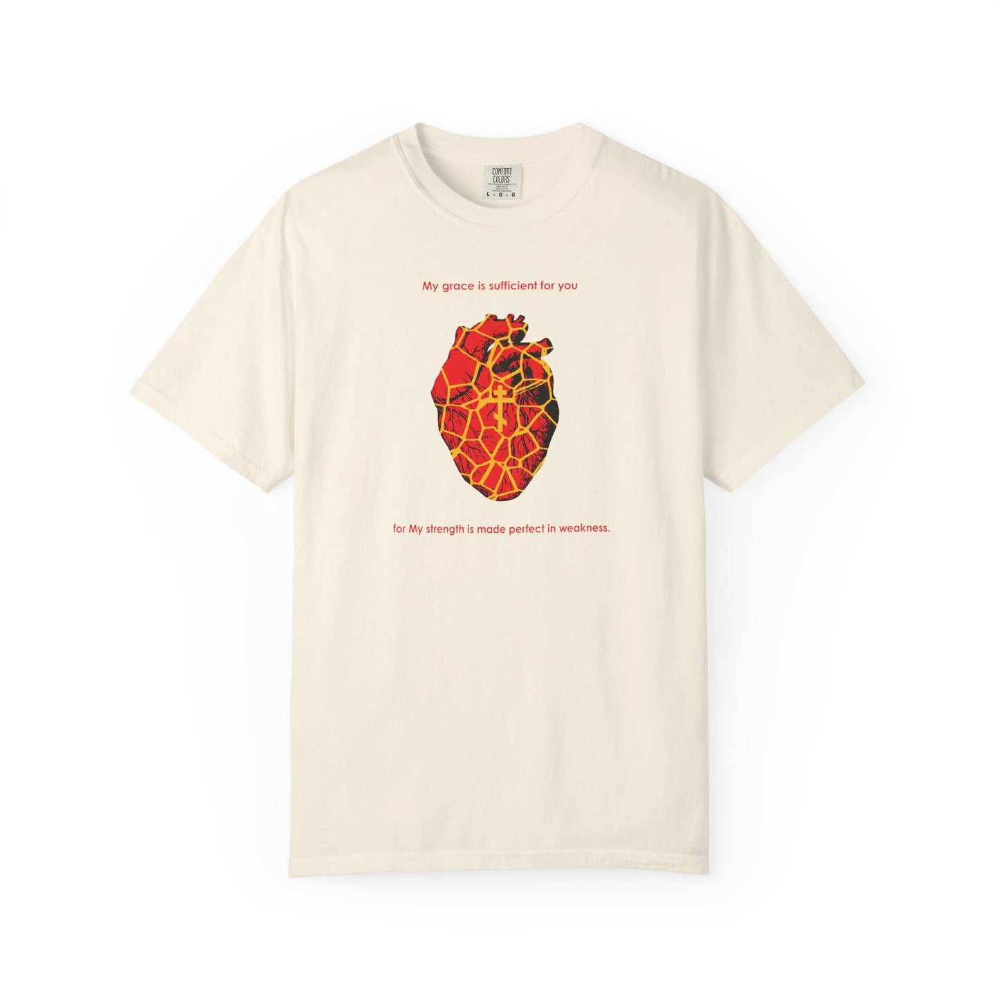 Ivory heavyweight cotton unisex tee featuring a Kintsugi-style golden broken heart with an Orthodox cross and the inspirational text “My Strength is Made Perfect in Weakness (2 Cor 12:9),” capturing the spirit of finding grace and beauty even in brokenness.