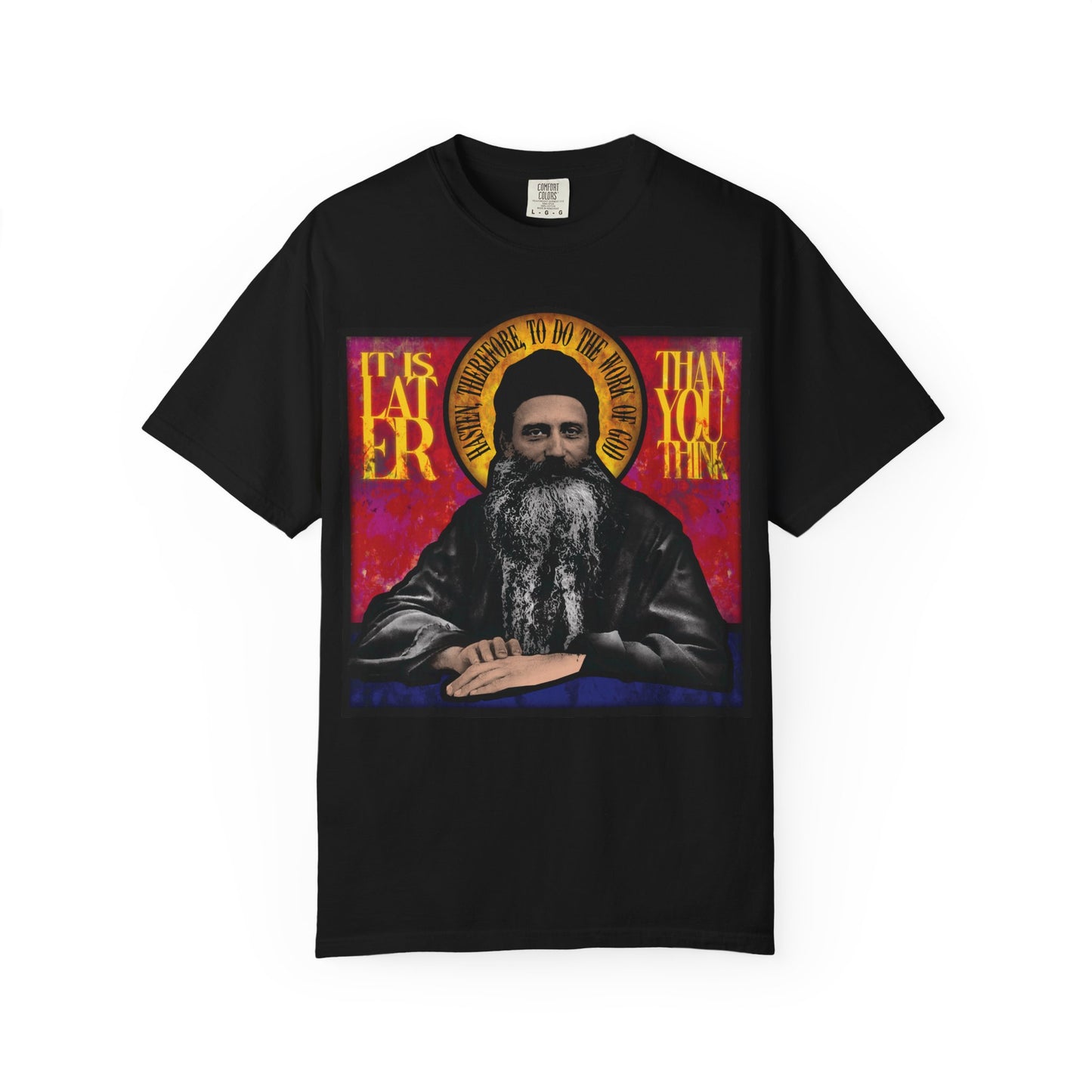 Black heavyweight cotton unisex t-shirt featuring a stained glass image of Fr. Seraphim Rose, an American Orthodox monastic saint, and the phrase "It is later than you think" as a timeless reminder.