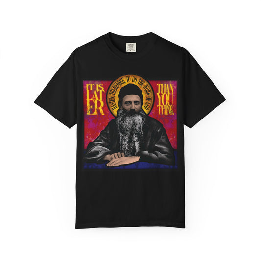 Black heavyweight cotton unisex t-shirt featuring a stained glass image of Fr. Seraphim Rose, an American Orthodox monastic saint, and the phrase "It is later than you think" as a timeless reminder.